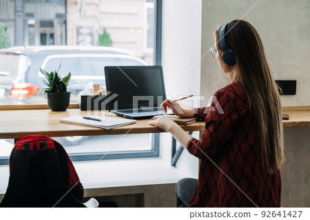 Part Time Business, Part-time job or side hustles concept. Young confident woman student in headset 92641427