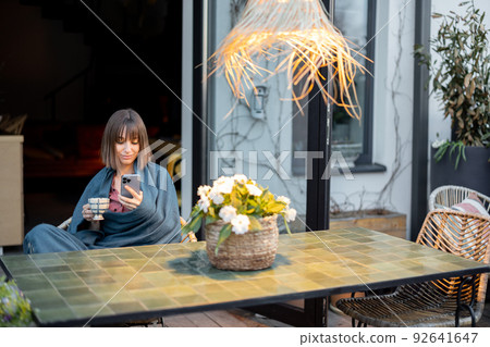 Woman relaxing at home terrace Woman relaxing at home terrace 92641647