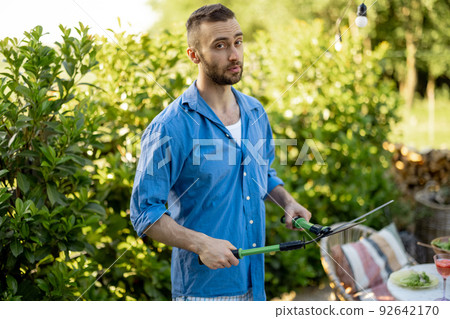 Handsome gardener works at garden 92642170
