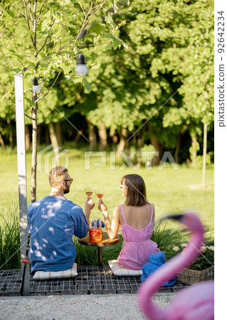 Young couple spend summer time with drink on nature 92642234