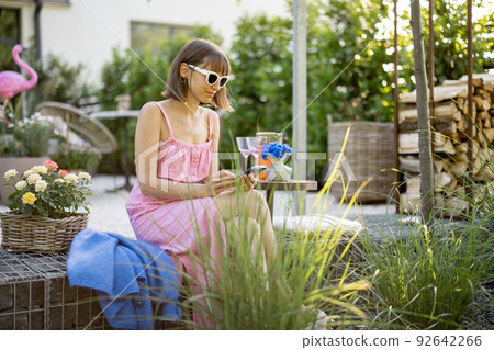 Woman with phone at backyard 92642266