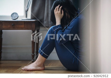 An image of a woman who is sad and depressed 92642912