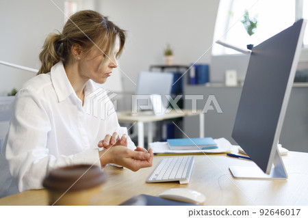 Business woman measures her heart rate Business woman measures her heart rate 92646017