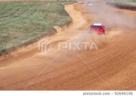gran turismo races on the autocross track, skidding, dust and dirt from under the tires gran turismo races on the autocross track, skidding, dust and dirt from under the tires 92646198