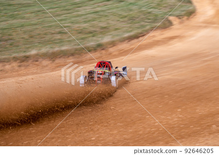 buggies on the autocross track, skidding, dust and dirt flying under the tires 92646205