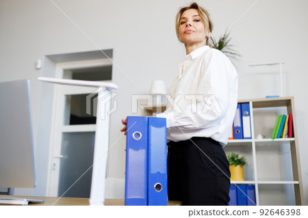 Secretary with folders for documents in the office 92646398