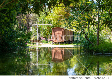 Greece, Kalamata, Old train with its reflection in the water in the Municipal Railway Park of Kalamata 92646597