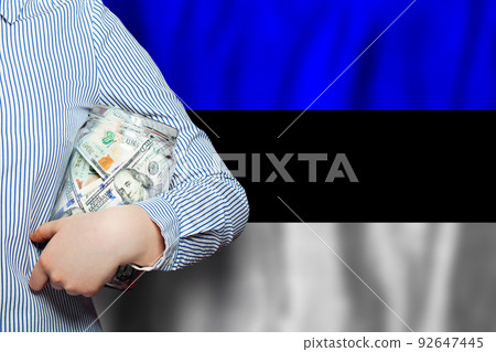 US dollars money and Estonian flag background. Business, banking and currency exchange in Estonia US dollars money and Estonian flag background. Business, banking and currency exchange in Estonia 92647445