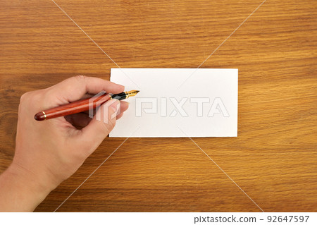 Woman writing by left hand. Left hander day concept. Woman writing by left hand. Left hander day concept. 92647597