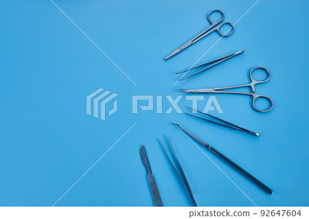 surgical equipment at surgery desk. Medical tools such scissors, scalpel. 92647604
