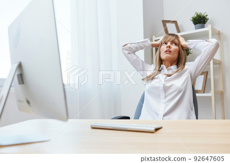 Frustrated adorable blonde businesswoman worker touch head both hands thinking of problem solution in light modern office. Scared employee work on computer online making big mistake. Copy space 92647605