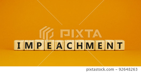 Impeachment symbol. Wooden cubes with the word 'impeachment'. Beautiful orange background, copy space. Business, impeachment concept. 92648263