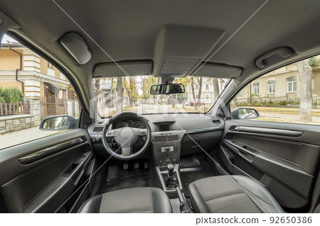 Luxurious car interior. Dashboard, steering wheel, gearshift and comfortable seats. Transportation, design, modern technology concept. 92650386