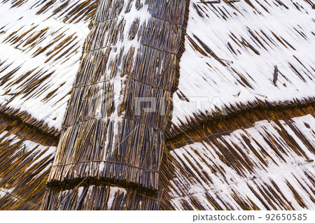Detail picture of roof made from straw with snow on it Detail picture of roof made from straw with snow on it 92650585