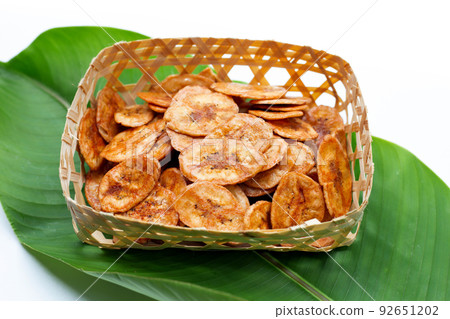 Banana chips on green leaf Banana chips on green leaf 92651202
