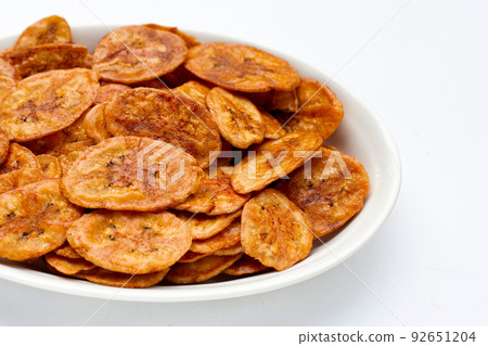 Banana chips on white background Banana chips on white background 92651204