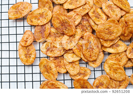 Banana chips on white background Banana chips on white background 92651208