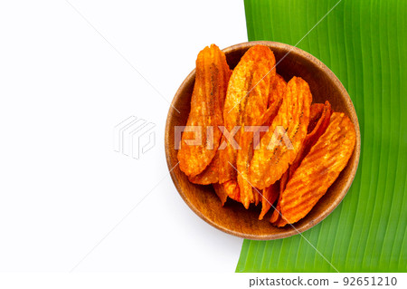 Spicy snack, Banana slice chips paprika flavor on white background. 92651210