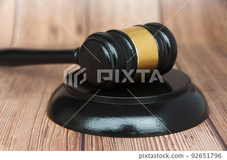 Close up of judge gavel on wooden desk background. 92651796