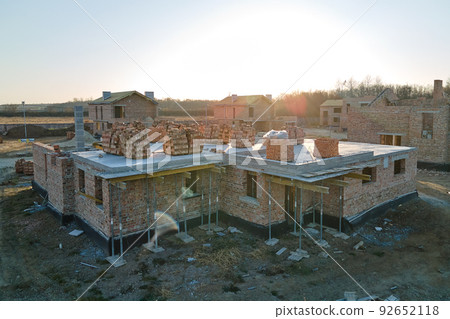Aerial view of residential houses under construction in rural suburban area. Real estate development Aerial view of residential houses under construction in rural suburban area. Real estate development 92652118