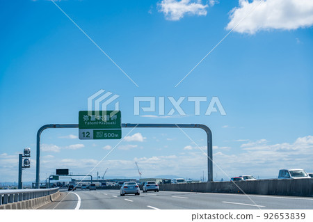 Aichi Prefecture: Passenger car driving at the Yatomi Kisosaki Interchange on the Ise Wangan Expressway Aichi Prefecture: Passenger car driving at the Yatomi Kisosaki Interchange on the Ise Wangan Expressway 92653839