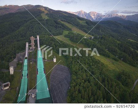 Hakuba ski jumping platform and Hakuba Sanzan dyed in the morning sun, Hakuba Village, Nagano Prefecture (Aerial shot by drone) Hakuba ski jumping platform and Hakuba Sanzan dyed in the morning sun, Hakuba Village, Nagano Prefecture (Aerial shot by drone) 92654720