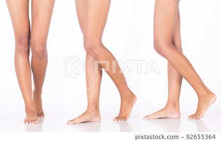 Tanned skin Woman show legs knee bare foots toe, walking forward side, white background isolated 92655364