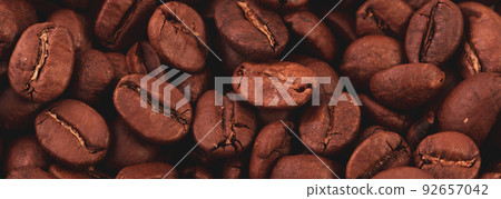 Coffee lover view of roasted coffee beans for background and texture. Dumped roasted coffee beans can be used as background and texture. Photo banner. roasted coffee Coffee lover view of roasted coffee beans for background and texture. Dumped roasted coffee beans can be used as background and texture. Photo banner. roasted coffee 92657042