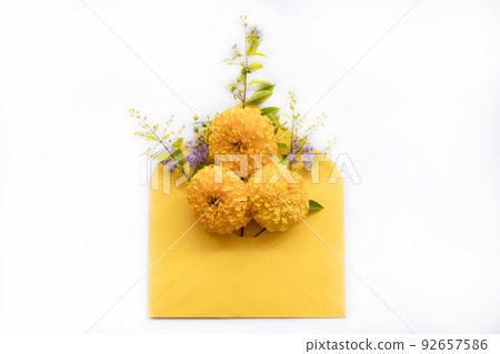 yellow flowers marigold in envelope arrangement flat lay postcard style  92657586