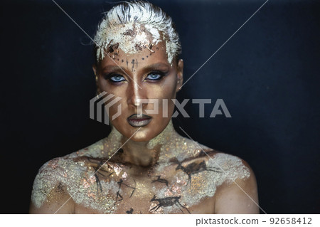 Creative makeup in the style of prehistoric cave painting Creative makeup in the style of prehistoric cave painting 92658412