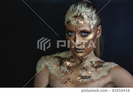 Creative makeup in the style of prehistoric cave painting Creative makeup in the style of prehistoric cave painting 92658416