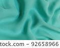 Green chiffon fabric crumpled or wavy fabric texture background. Abstract linen cloth soft waves. Silk yarn. Smooth elegant luxury cloth texture. Concept for banner or advertisement. 92658966