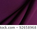 Purple crumpled or wavy fabric texture background. Abstract linen cloth soft waves. Gabardine wool fabric. Merino yarn. Smooth elegant luxury cloth texture. Concept for banner or advertisement. 92658968