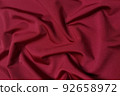 Red supplex crumpled or wavy fabric texture background. Abstract linen cloth soft waves. Silk fabric. Smooth elegant luxury cloth texture. Concept for banner or advertisement. 92658972