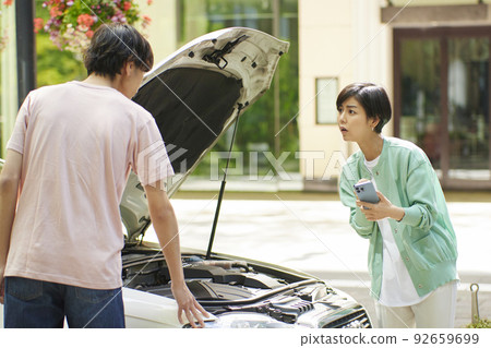 Young woman calling due to car breakdown Young woman calling due to car breakdown 92659699