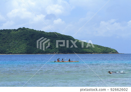 People enjoying marine sports in the beautiful ice blue sea of Ida Beach on Iriomote Island People enjoying marine sports in the beautiful ice blue sea of Ida Beach on Iriomote Island 92662602