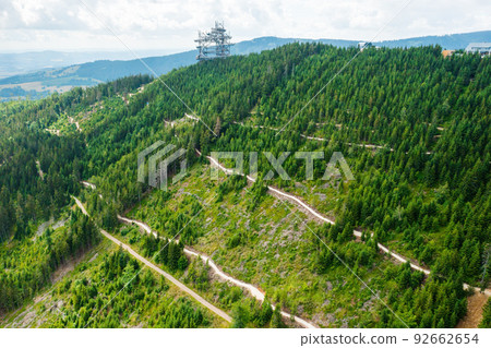 Aerial view of the worlds longest 721 meter suspension footbridge Sky bridge and observation tower the Sky walk in the forest, between mountains, Dolni Morava Ski Resort, Czech Republic.  92662654