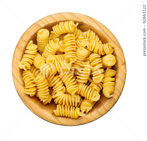 Pasta close-up. Fusilli spirale in a bowl, isolated on white background.  92663122