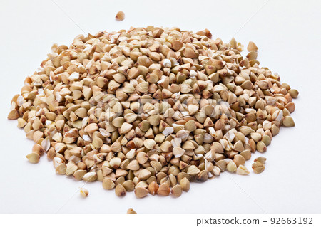 Pile of buckwheat seeds isolated on white background, closeup. Pile of buckwheat seeds isolated on white background, closeup. 92663192