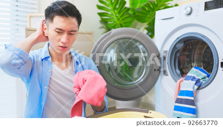 man irritated about laundry 92663770