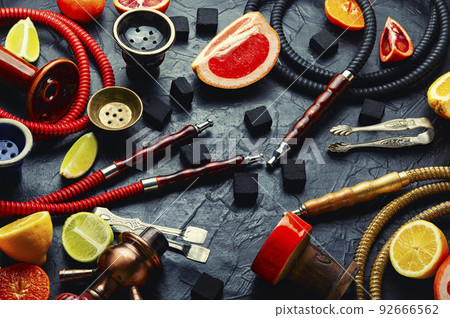 Smoking hookah with citrus fruits. Smoking hookah with citrus fruits. 92666562