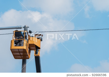 Blue sky and electrical work platform 92666596
