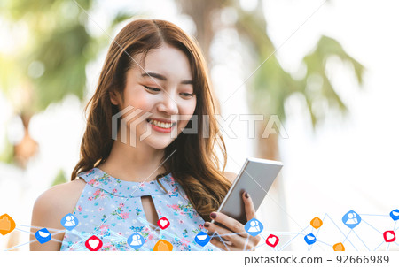 Asia young shopper woman use social network by smartphone 92666989