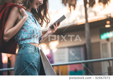 Adult asian woman shopping and payment currency online by internet. Adult asian woman shopping and payment currency online by internet. 92667072