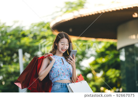 Adult asian woman shopping and payment currency online by internet. Adult asian woman shopping and payment currency online by internet. 92667075