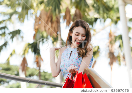 Young asian woman happy wow with shopping bag. Young asian woman happy wow with shopping bag. 92667076