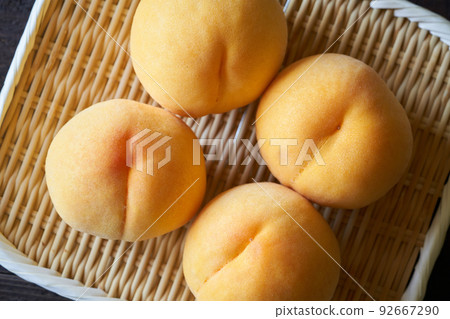 Yellow peach on a colander 92667290