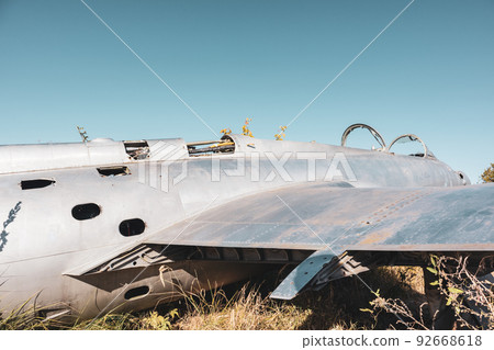 Old L-29 plane fuselage and wing close in field 92668618