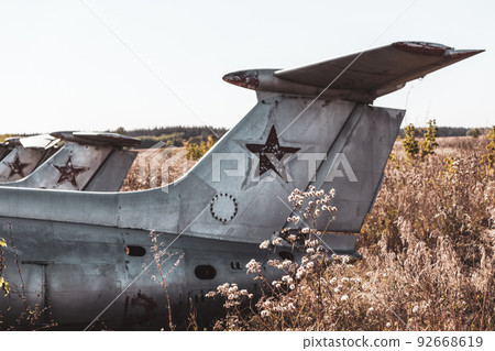 Old soviet L-29 plane fuselage empennage in field 92668619