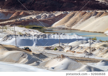 Sand extraction with machinery at quartz quarry Sand extraction with machinery at quartz quarry 92668688